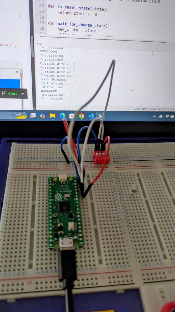 Raspberry Pi Pico on a breadboard in front of a laptop screen showing the Thonny development environment. The program is running and the debug output can be seen.
