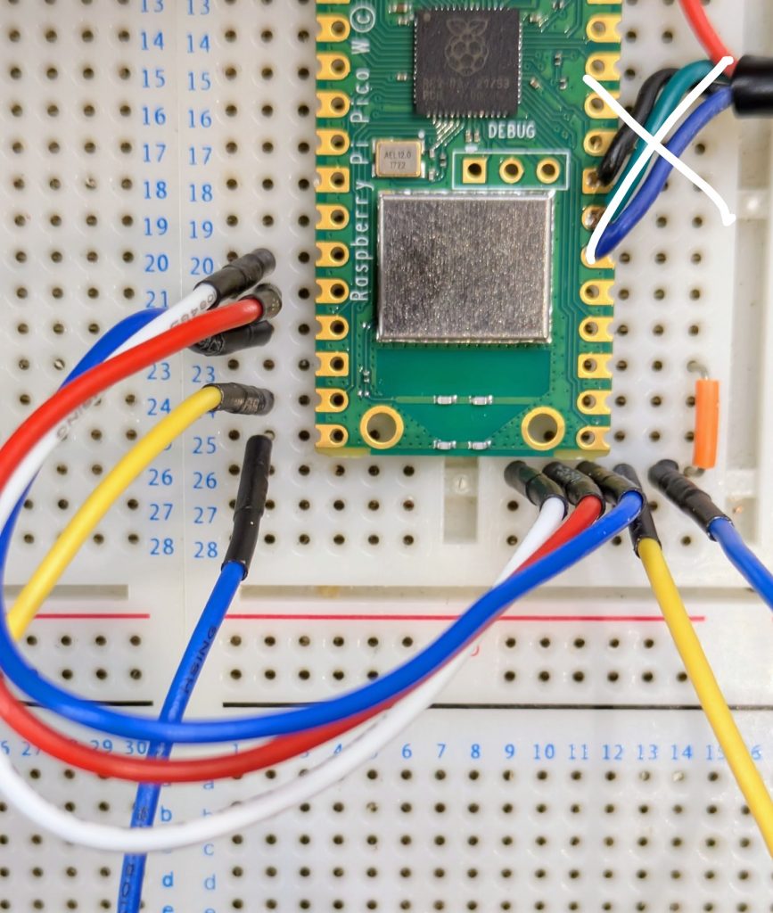 The end of a Pi Pico held against breadboard with the puzzle wires shown